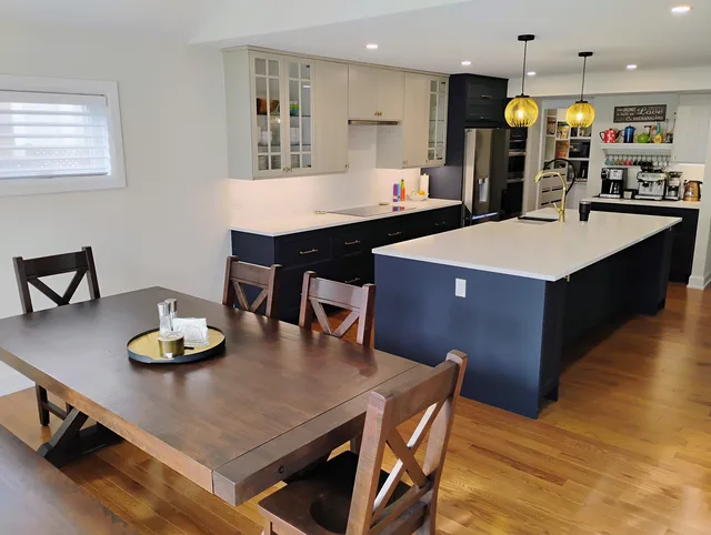 Renovated kitchen with blue cabinetry and a white island