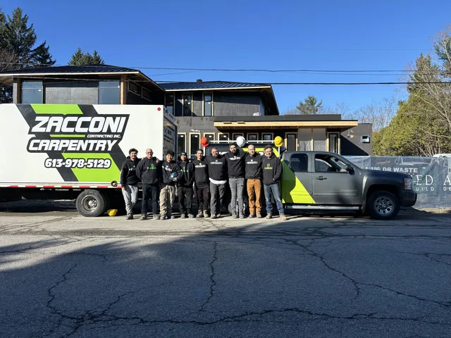 Zacconi crew beside their branded truck and carpentry trailer